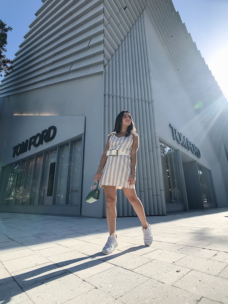 Tom Ford Tobacco Vanille Reviewed: Sexy, Spicy & Genderless Model posing near Tom Ford outlet