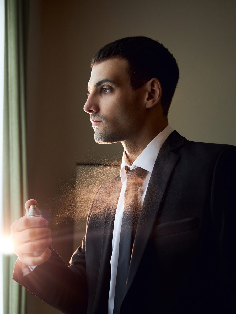 11 Best Niche Fragrances For Men: Express Your Personality With Style man applying cologne