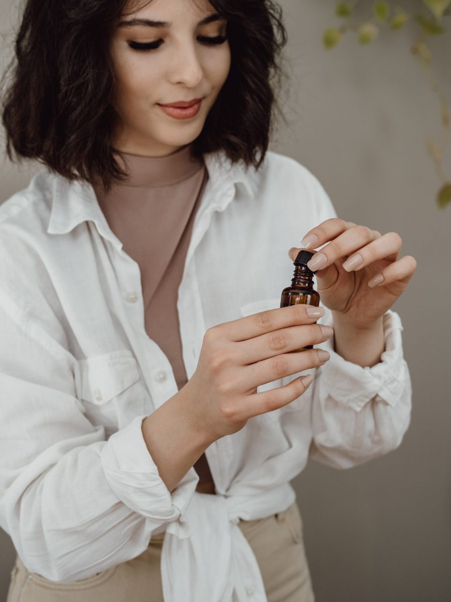 What Does Vetiver Smell Like? woman applying vetiver essential oil