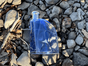Nautica Blue Review: True Blue Bargain or Basic Everyday Scent? nautica blue - bottle on rocks
