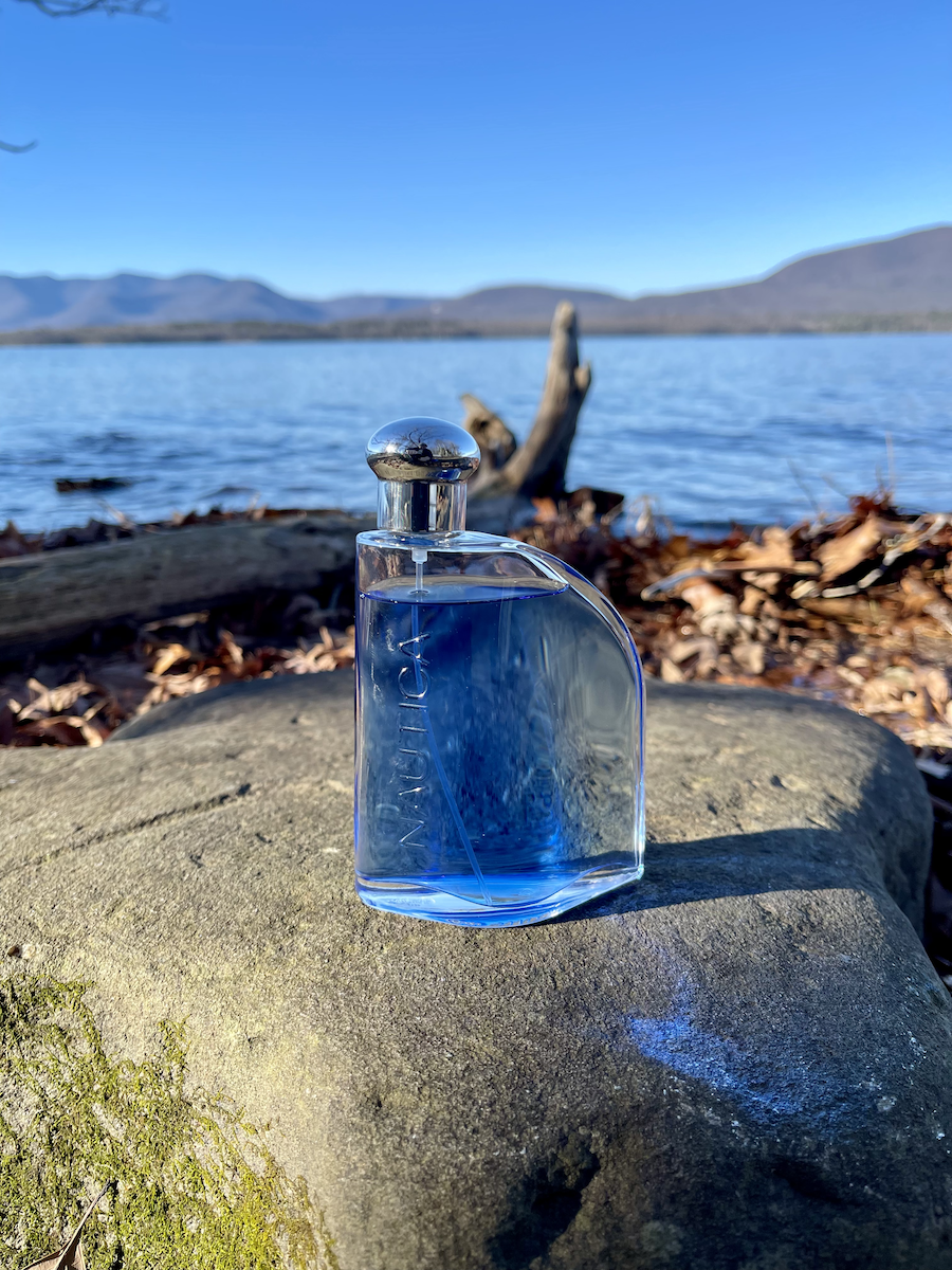 Nautica Blue Review: True Blue Bargain or Basic Everyday Scent? nautica blue cologne bottle on rock